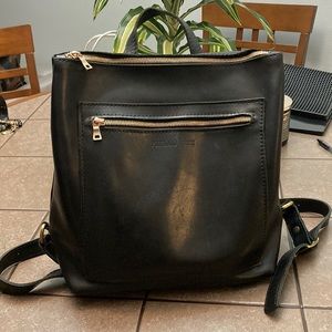 Black leather backpack. Lots of room. Nice condition. This will last for years.